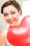 Bride with red heart shaped balloon