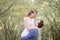 Bride in red wreathe smiles to a groom while he holds her up