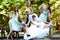 Bride rises her legs up while resting with bridesmaids on the be