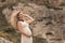 The bride on a romantic walk during pregnancy in the summer walks on the rocks