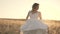 Bride Runs in the Field at Sunset