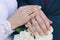 The bride& x27;s bouquet. Rings newlyweds. A bouquet of flowers with rings. Hands newlywed