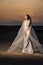 Bride in sand dunes on mountain landscape