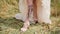 Bride shown a tattoo on her leg under a wedding dress. Surprising view of a colourful tattoo with a picture of a woman