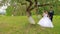 The bride sits on a beautiful swing