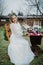 Bride sits near banquet table with candles and flower arrangement