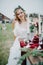 Bride sits near banquet table with candles and flower arrangement