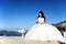 Bride sitting down in a port in Santorini, GREECE