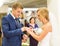 Bride slipping ring on finger of groom at wedding