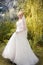 Bride stand on a green grass