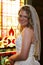 Bride standing in front of stained glass window