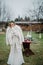 Bride stands near banquet table dressed in jacket