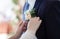 The bride straightens the groom`s boutonniere. No faces