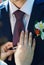 Bride straightens to groom his tie.