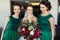 Bride surrounded by braidsmaids reach out her hand with bouquet