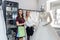 Bride with tailor choosing wedding dress in store