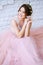 Bride in a tender light pink wedding dress in a morning