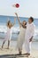 Bride Throwing Bouquet On Beach