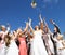 Bride Throwing Bouquet For Guests To Catch