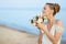 Bride walking along sea coast in wedding dress