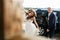 Bride walks dancing in the sunlight while groom closes a car behind her