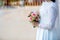 Bride wear white bride dress holding fresh beautiful flower bouquet