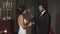 The bride wears a wedding ring to the groom in a fabulous location with candles, the lovers look into each other\'s eyes and