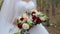 Bride with wedding bouquet in the forest