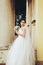 Bride with a wedding bouquet in her arms poses in the passage be