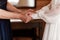 Bride on wedding day holding her mother`s hands. an old woman holds her young daughter married