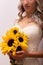 Bride in a wedding dress with a bouquet of sunflowers.Beautiful woman.Floristics