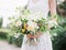 Bride in wedding dress with bouquet. Wedding style.