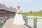 Bride in wedding dress posing near the water villas