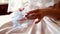 Bride at the wedding fingering in the hands of a garter