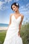 Bride in wedding gown on beach