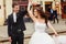 Bride whirls around groom`s hand on the city square