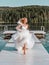 Bride in white chic wedding dress running barefoot to meet happiness, wedding concept