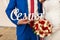 The bride in white dress and groom in blue suit holding wooden inscription â€œFamilyâ€. Wedding