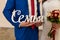 The bride in white dress and groom in blue suit holding wooden inscription â€œFamilyâ€. Wedding