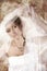 Bride in white veil at vintage background.