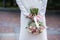 The bride in a white wedding dress is holding a bouquet of white flowers - peonies, roses. Wedding. Bride and groom. Delicate