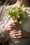 The bride in a white wedding dress is holding a bouquet of white flowers - peonies, roses. Wedding. Bride and groom. Delicate