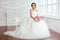 The Bride. Young women with wedding dress in very bright room,