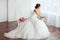 The Bride. Young women with wedding dress in very bright room,