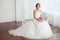The Bride. Young women with wedding dress in very bright room,