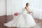 The Bride. Young women with wedding dress in very bright room,