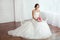 The Bride. Young women with wedding dress in very bright room,