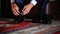 Bridegroom ties laces on his black patent shoes.