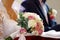 The brides bouquet at the church on the kneeler