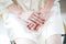 Brides hands on white dress